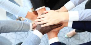 Group of business people joining hands